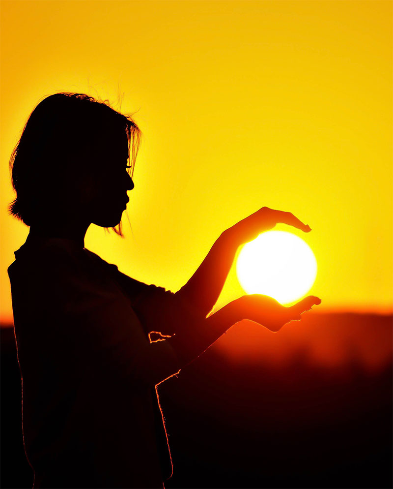 guidance-service-home3 Woman holding the light of the sunrise in her hands